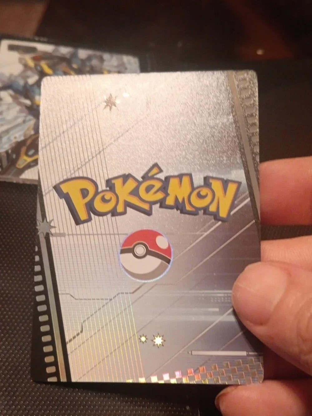 Pokemon Trading Card with Blue, White, Gold and Orange Mech Artwork
